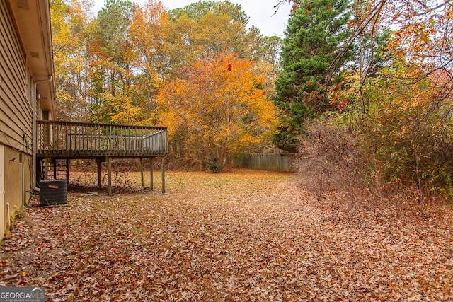 view of yard with cooling unit and a wooden deck