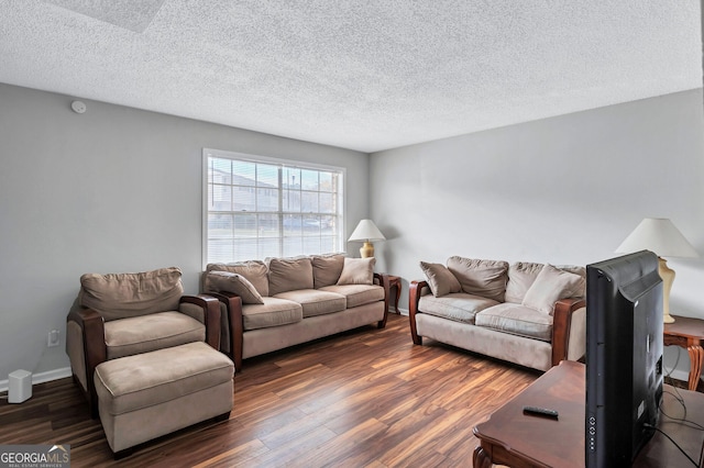 living room with dark wood-type flooring and a textured ceiling