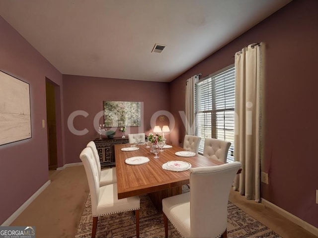 dining space with light colored carpet