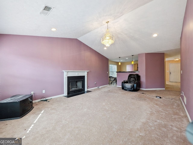 unfurnished living room featuring lofted ceiling, a chandelier, and carpet