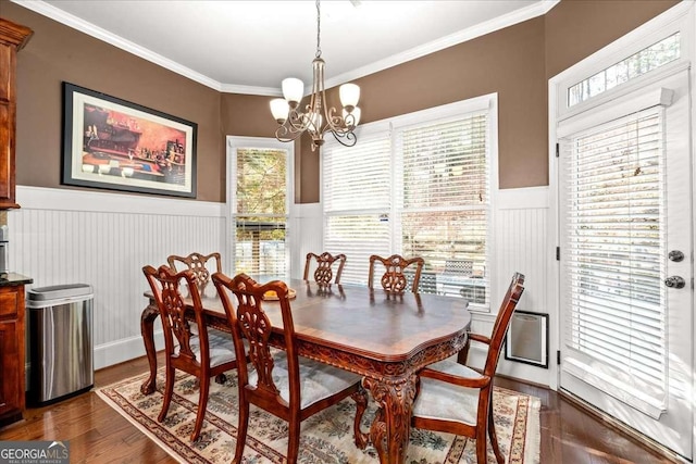 dining space with a notable chandelier, dark hardwood / wood-style flooring, plenty of natural light, and ornamental molding