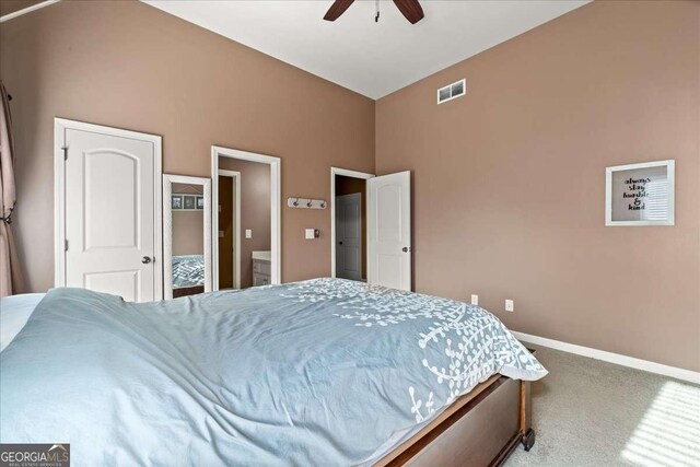 carpeted bedroom with ceiling fan and vaulted ceiling