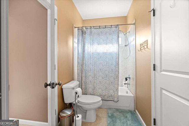 bathroom featuring tile patterned flooring, toilet, and shower / tub combo