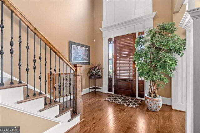 entrance foyer featuring a high ceiling and hardwood / wood-style flooring