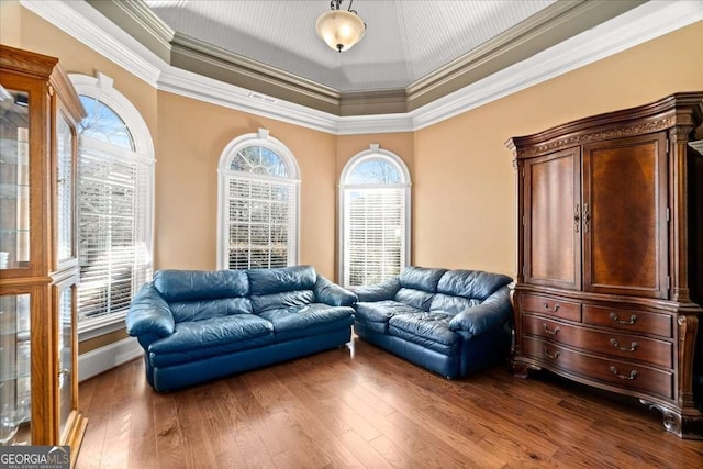 living area featuring wood-type flooring and ornamental molding