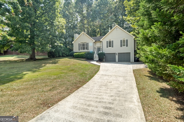 view of front of home with a front yard and a garage