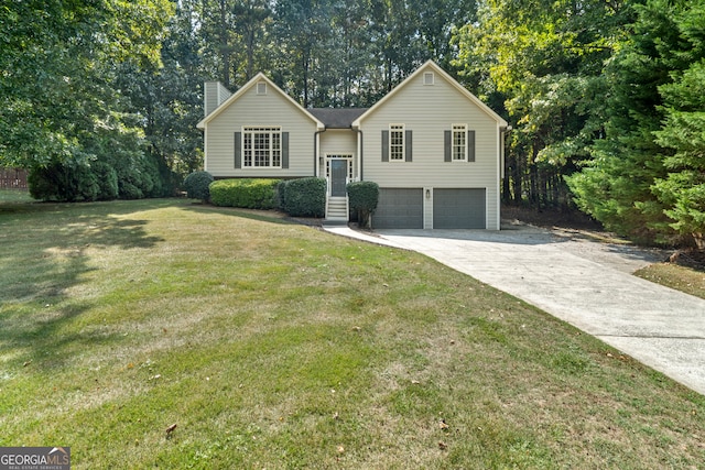 raised ranch featuring a garage and a front yard