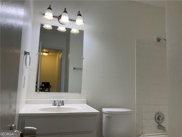 full bathroom with vanity, toilet, and tiled shower / bath