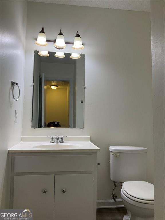 bathroom with vanity and toilet