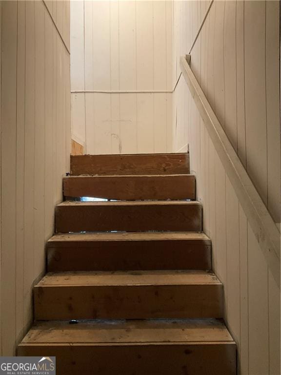 stairs with wood walls