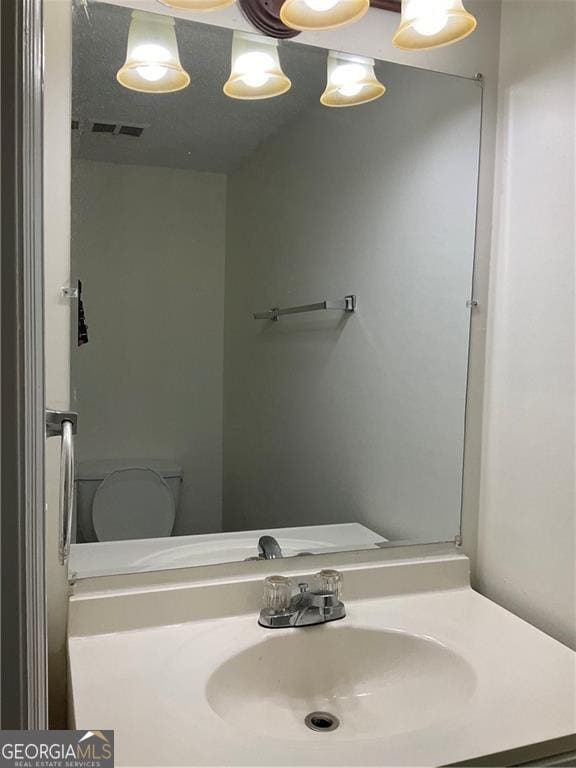 bathroom with vanity and toilet