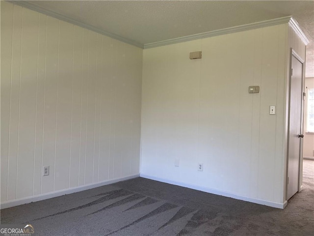 carpeted spare room featuring crown molding