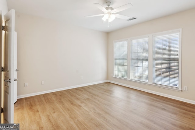 spare room featuring light hardwood / wood-style floors and ceiling fan