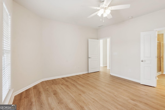 unfurnished room with ceiling fan and light wood-type flooring