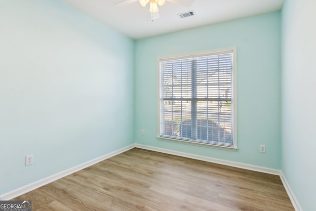 spare room with ceiling fan and light wood-type flooring