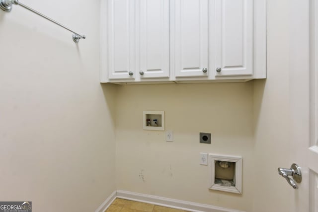 clothes washing area featuring electric dryer hookup, hookup for a washing machine, and cabinets