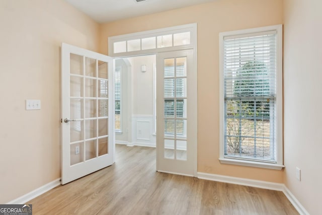 doorway to outside featuring french doors and light hardwood / wood-style floors