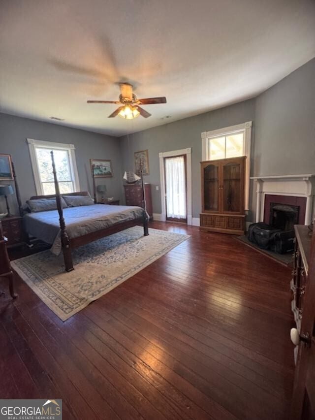 bedroom with ceiling fan and dark hardwood / wood-style flooring