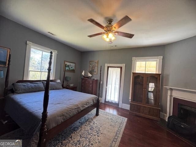 bedroom with ceiling fan and dark hardwood / wood-style flooring