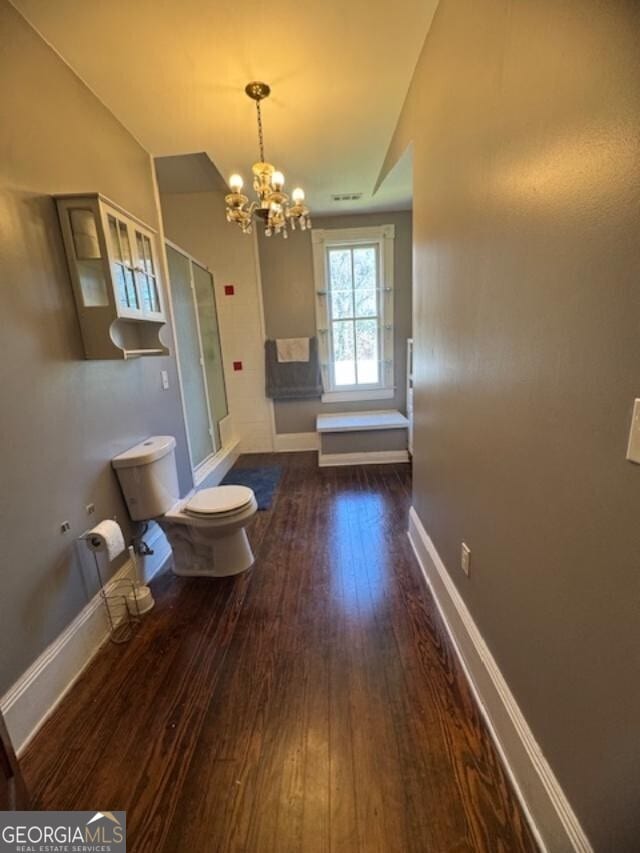 interior space featuring dark hardwood / wood-style flooring and a chandelier