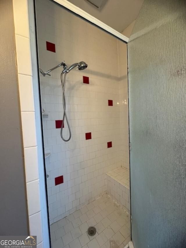 bathroom with tiled shower