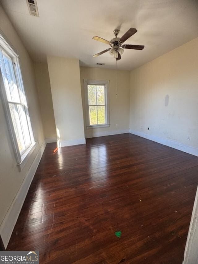 unfurnished room featuring dark hardwood / wood-style flooring and ceiling fan