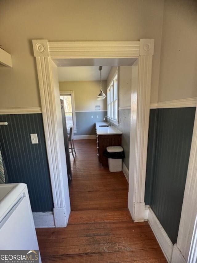 hall featuring sink and dark hardwood / wood-style floors