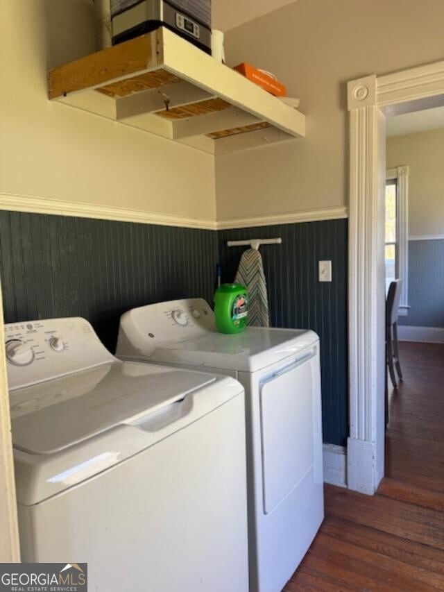 laundry area featuring dark hardwood / wood-style flooring and washing machine and clothes dryer