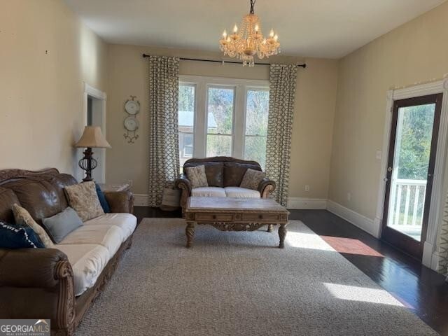 living room with a chandelier and dark hardwood / wood-style floors