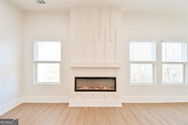 unfurnished living room with light hardwood / wood-style floors