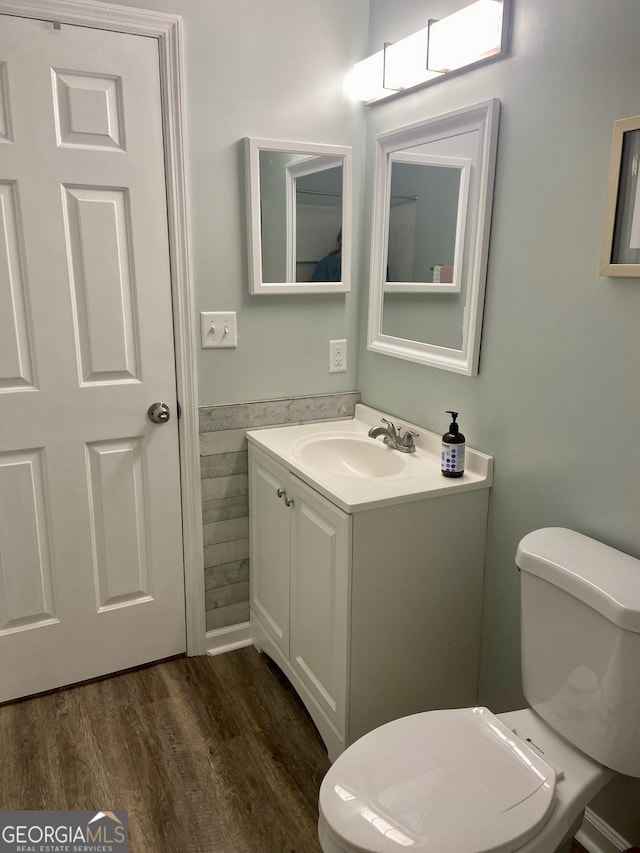 bathroom with vanity, toilet, and wood-type flooring