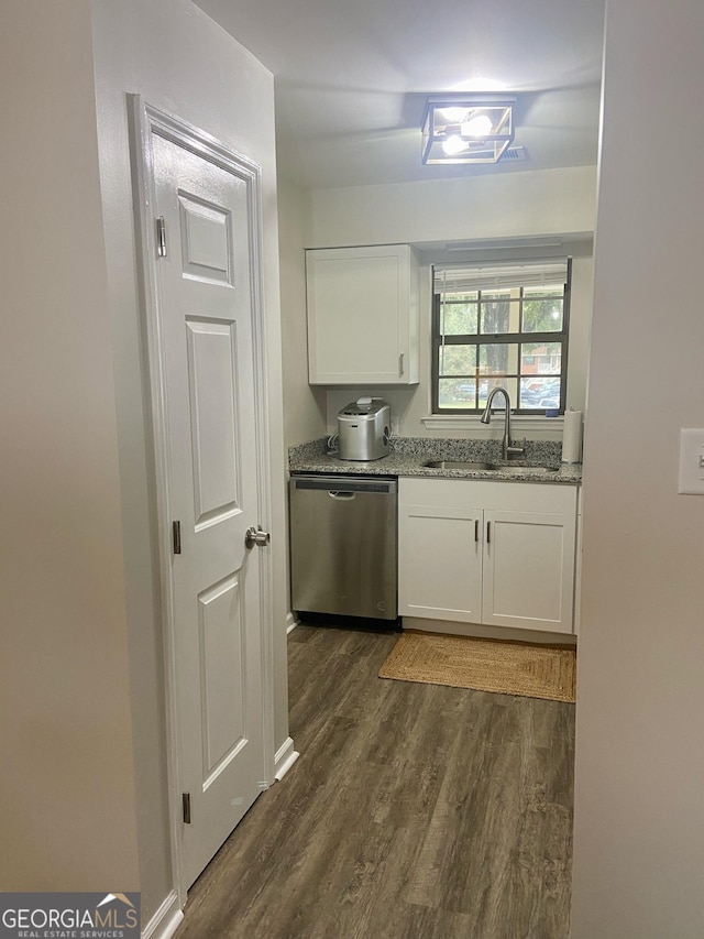 kitchen with stainless steel dishwasher, white cabinetry, sink, and dark wood-type flooring