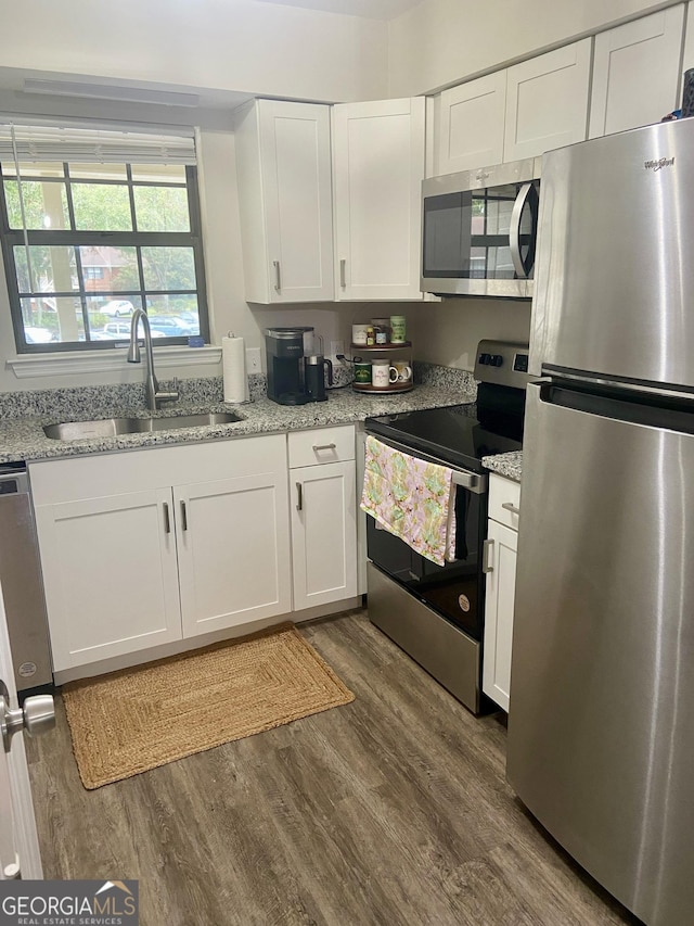 kitchen with white cabinets, stainless steel appliances, and sink