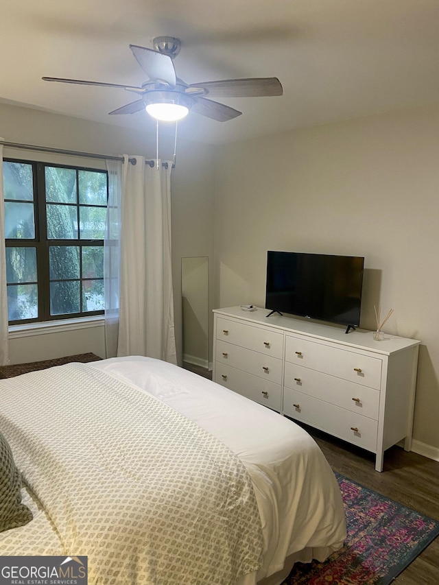 bedroom featuring ceiling fan and dark hardwood / wood-style flooring