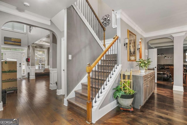 stairs with wood-type flooring and ornamental molding