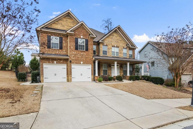 craftsman-style house with a garage, concrete driveway, brick siding, and covered porch