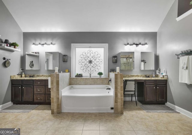 bathroom featuring tile patterned flooring, vanity, lofted ceiling, and a tub to relax in