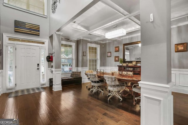 dining area featuring beam ceiling, dark wood-type flooring, ornate columns, and coffered ceiling