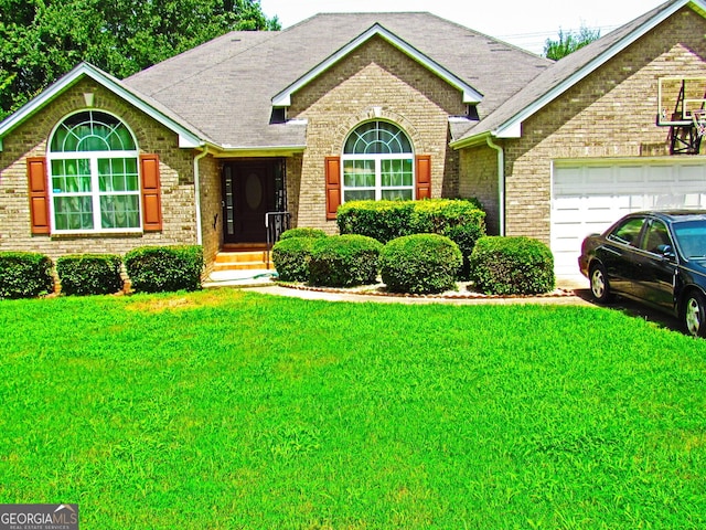 view of front of property featuring a garage and a front yard