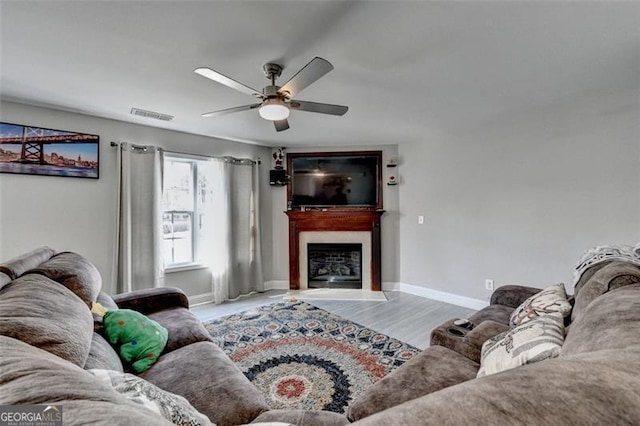 living room featuring hardwood / wood-style floors and ceiling fan