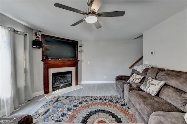 living room featuring ceiling fan and light wood-type flooring