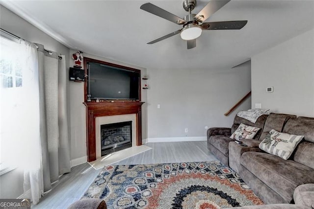 living room featuring ceiling fan and light hardwood / wood-style flooring