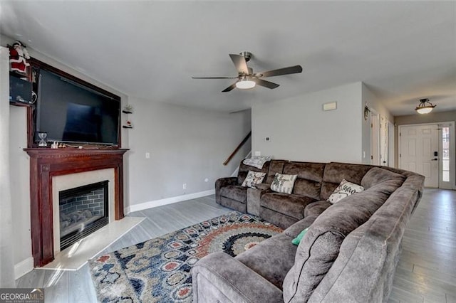 living room with wood-type flooring and ceiling fan