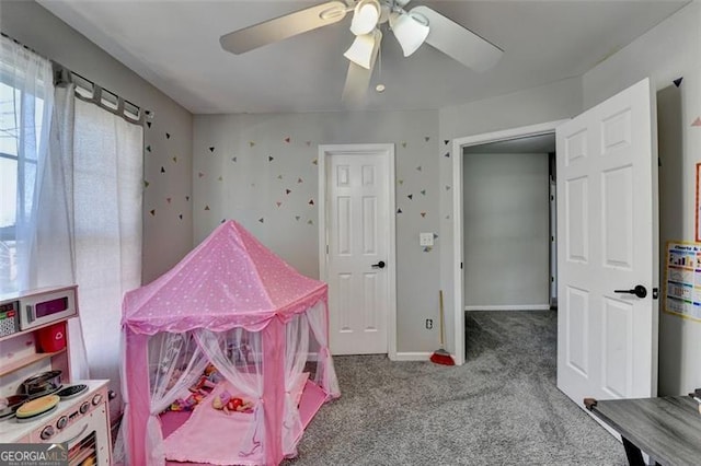 recreation room with ceiling fan and carpet floors