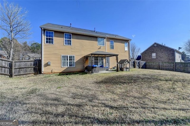 back of house with a gazebo and a patio area