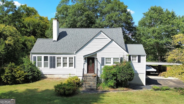 cape cod-style house with a front lawn and a carport