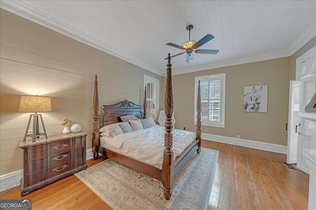 bedroom with ceiling fan, baseboards, light wood-style flooring, and crown molding