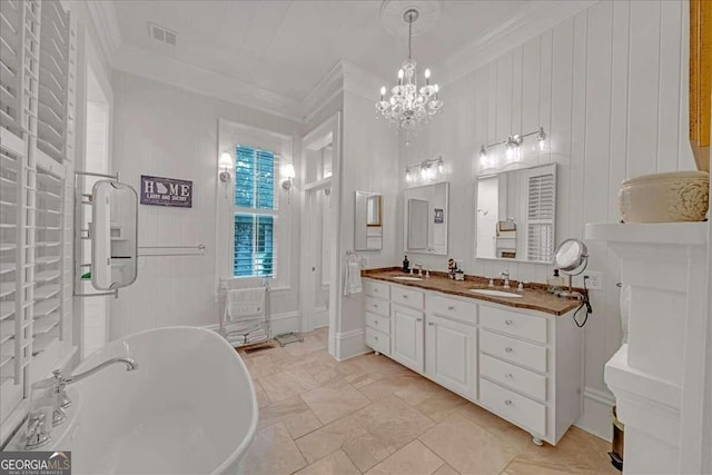 bathroom with vanity, ornamental molding, a bath, and an inviting chandelier