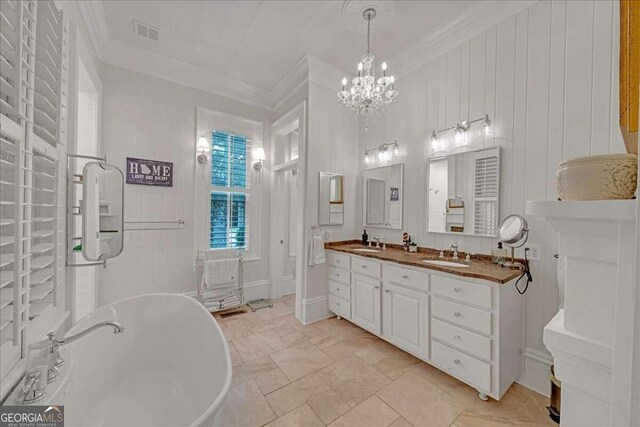 full bath featuring visible vents, ornamental molding, a freestanding tub, and a sink