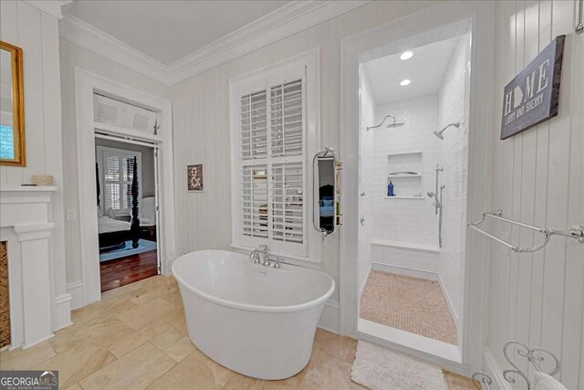 bathroom with a freestanding tub, crown molding, and a tile shower
